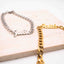 Two name bracelets, one silver and one gold, on a textured surface.