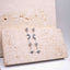 Pair of silver earrings with blue gemstones on a textured beige surface