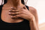 Close-up of a person wearing Layered Chain Bracelet ā Model wearing Gold option, styled with rings