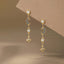 Moon & Star Drop Earrings display on a board