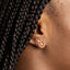Tiny Gold CZ Stud Earrings worn in lobe, showcasing delicate design and 18K gold-plated finish.