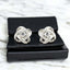 Moissanite Knot Stud Earrings on a display