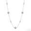 Silver clover station necklace with pearls and floral motifs on a white background