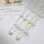 Two necklaces with circular and clover-shaped pendants on a light background.