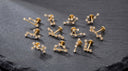 Zodiac Constellation CZ Flat Back Earring – 16G Push Pin Cartilage Stud -Twelve gold-toned astrological sign stud earrings arranged on a dark slate background, each labeled with its corresponding zodiac name and date range.