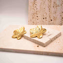 Side angle of 18K gold-plated flower stud earrings with textured petals