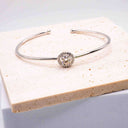 Halo Moissanite Bangle presented on a neutral display block to highlight the 1 carat moissanite centrepiece.