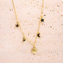 Gold necklace with star, moon, and sun pendants on a textured beige background-Gold Celestial Gypsy Necklace – Station Necklace

18K Gold-Plated | Celestial | Hypoallergenic
