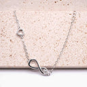 Infinity and Heart Moissanite Bracelet in rhodium-plated 925 sterling silver with VVS moissanite centre stone.
