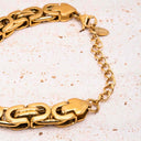 Bold Link Chain Bracelet featuring sculpted links and 18K PVD gold plating on a textured surface.