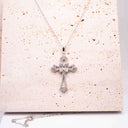 Radiant Cross Moissanite Necklace in rhodium-plated sterling silver with VVS moissanite stones.