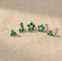 Set of green floral hairpins on a beige fabric background
