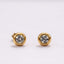 Mini CZ Stud Earrings –  4mm Gold PVD Stainless Steel, Gold stud earrings with clear gemstones on a light grey background