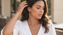 Woman wearing a white blouse with a blurred outdoor background