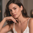 Woman wearing a white lace top with a blurred background