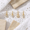Mini Clicker Hoop Earrings 16G – Gold CZ Rook Cartilage & Tragus Piercing, on white broiderie Anglaise fabric.