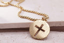Engraved cross necklace featuring the Lord's Prayer on a circular gold stainless steel pendant with a cross cut-out.