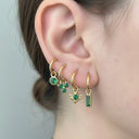Emerald Charm Clicker Hoop Earrings showcased in gold with green gemstones in multiple styles on an ear.