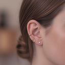 Close-up of an ear wearing Surgical Steel Clicker Hoop – Waterproof & Hypoallergenic with a blurred background