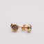 Mini CZ Stud Earrings –  4mm Gold PVD Stainless Steel. Gold stud earrings with clear gemstones on a light grey background