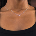 Necklace with a heart-shaped pendant on a person's neck