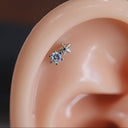Close-up of an ear with a diamond stud earring.