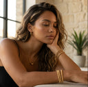 Woman with gold jewelry in a casual setting