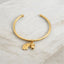 Gold acorn charm bangle bracelet crafted from sterling silver with premium finish