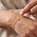 Gold bracelet with letter 'A' on a wrist