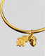 Close-up of acorn and leaf charm on gold plated sterling silver bangle