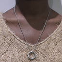 Minimal Circle Pendant Necklace with a circular pendant on a person wearing a beige sweater.