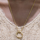 Minimal Circle Pendant Necklace on a textured beige sweater.