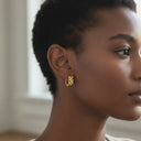 Chunky Link Huggie Hoop Earrings – Gold Stainless Steel worn by a model, showcasing a bold statement design.