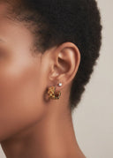 Chunky Link Huggie Hoop Earrings in gold stainless steel worn on a model's ear, showcasing a bold, stylish look.