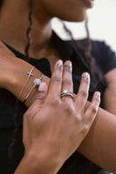 Halo Moissanite Bangle Lifestyle shot – worn on wrist, Halo Moissanite Bangle styled on wrist, showing the elegant sparkle and slim sterling silver cuff.