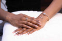 Cross Link Bracelet showcased on a woman's wrist, featuring gold and silver accents, adjustable, and hypoallergenic.