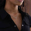 Rhodium plated sterling silver moissanite drop necklace worn on a model, showing elegant long chain length
