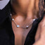 Clover and Pearl Station Necklace – Gold or Silver, on a model wearing a black top