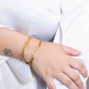 Custom Name Bracelets Gold – Waterproof & Tarnish Free. Gold bracelet on a wrist with a white background