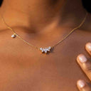 Close up of 5-Stone CZ Crown Necklace – Dainty, Hypoallergenic, 925 Silver. Ella and Faith London on a person's neck