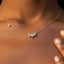 Close up of 5-Stone CZ Crown Necklace – Dainty, Hypoallergenic, 925 Silver. Ella and Faith London on a person's neck