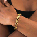 Bold gold link chain bracelet on wrist, 18K PVD gold-plated stainless steel.
