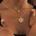 Gold necklace with star, moon, and sun pendants on a textured beige background-Gold Celestial Gypsy Necklace – Station Necklace

18K Gold-Plated | Celestial | Hypoallergenic styled with Gold necklace with a tree of life pendant on a person's neck