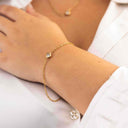The Mini CZ Bracelet on a wrist with a white shirt background