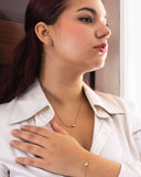 Model wearing a Mini CZ Bracelet in Gold PVD Plated Stainless Steel, showcasing everyday elegance with matching earrings.