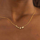Gold necklace with star and moon pendant on a person's neck against a brown background-Moon &amp; Star Necklace – 14K Gold Over 925 Silver, CZ Gemstones

Celestial Charm | CZ Gemstones | Hypoallergenic Ella and Faith London