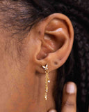 Close-up of butterfly and chain detail on sterling silver drop earrings