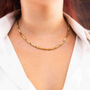 Sculpted Link Necklace in PVD gold-plated stainless steel. worn by a person with a white shirt