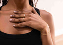Close-up of a person wearing Layered Chain Bracelet – Model wearing Gold option, styled with rings