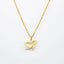 Gold necklace with a heart-shaped pendant on a white background